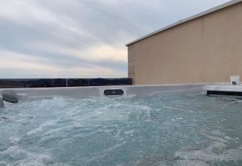 Olive Oasis Penthouse With Jacuzzi has rooms with a private hot tub