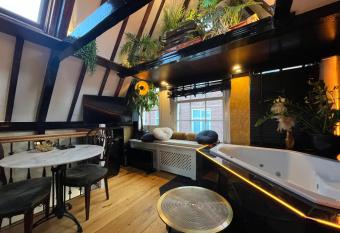 The Enlightened House Luxury Suites has rooms with a private hot tub