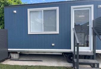 Sweet Cute blue tiny home with Pool and 2 minute drive to the beach allows 18 year olds to book a room