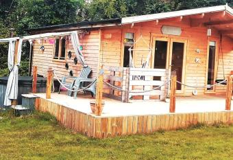 Luxury log cabin with wood fired hot tub has rooms with a private hot tub