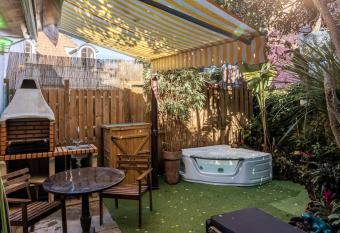 Unique Tiny Smart Home with Private Garden, Jacuzzi, PS5, Cinema Projector has rooms with a private hot tub