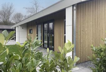 Beautiful chalet on the water in a holiday park has Balcony rooms