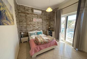 2-Bedroom Blue & White House with Garden and Beach has Balcony rooms