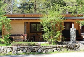 Wooden lodge with jacuzzi has rooms with a private hot tub
