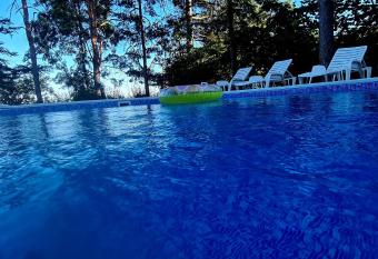 Vila Sinfonia, a house with a pool has rooms with a private hot tub