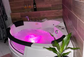 Pink House Apartments has rooms with a private hot tub