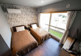 Few Days Condominium with Open Air Bath has rooms with a private hot tub