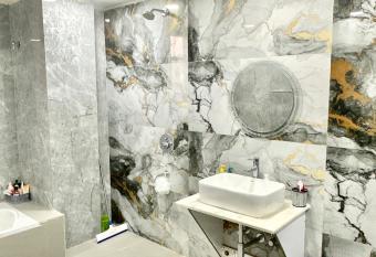 1 Deluxe & Spacious Master Bedroom with attached Washroom & Bathtub has rooms with a private hot tub