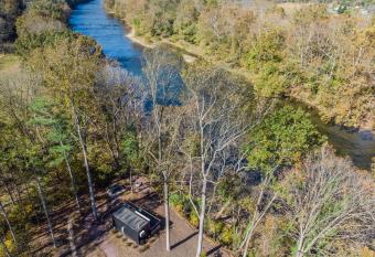 Riverside Retreat w 3 Cabins Hot Tubs & Kayaks allows 18 year olds to book a room