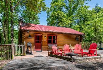 Romantic log cabin with hot tub has rooms with a private hot tub