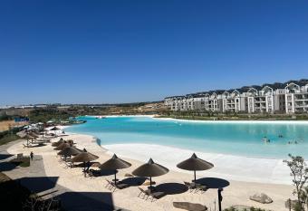 Lagoon Facing Apartment has rooms with a private hot tub